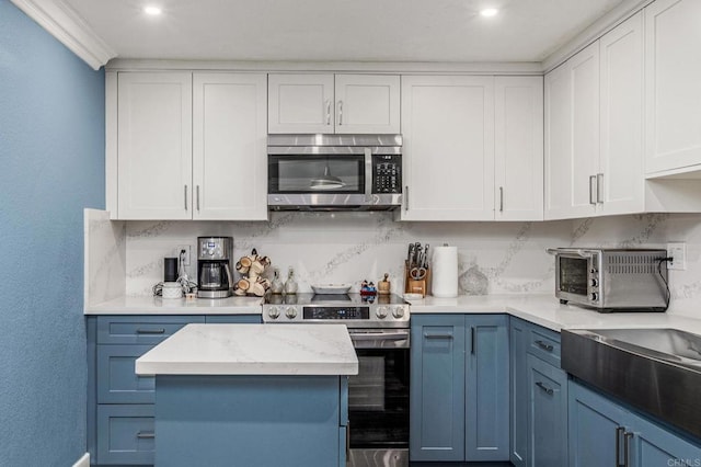 kitchen featuring decorative backsplash, white cabinetry, and stainless steel appliances