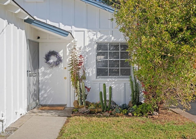 doorway to property featuring board and batten siding