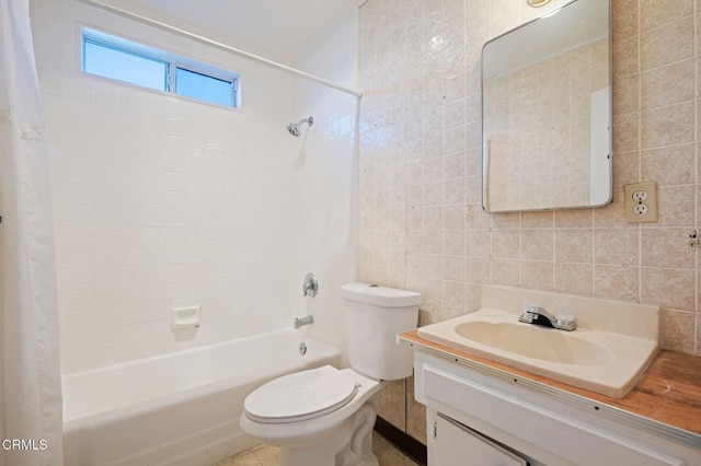 bathroom featuring backsplash, tile walls, toilet, shower / bath combo with shower curtain, and vanity