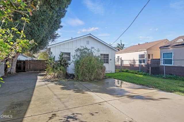 rear view of property with a patio area, a lawn, and fence