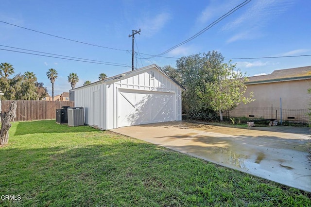 detached garage with fence and central AC