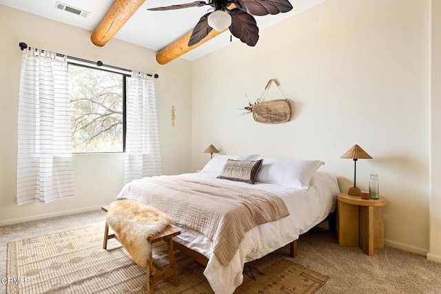 carpeted bedroom featuring beam ceiling, baseboards, visible vents, and ceiling fan