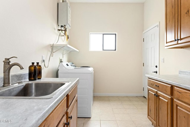 clothes washing area with baseboards, water heater, cabinet space, independent washer and dryer, and a sink