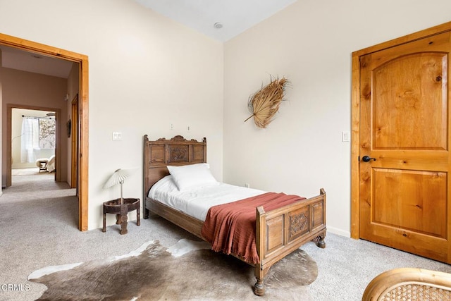 bedroom featuring light carpet