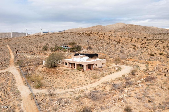 drone / aerial view with a mountain view and view of desert