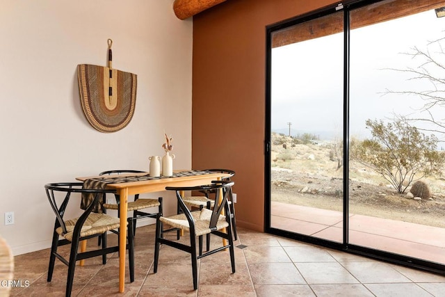 dining room featuring light tile patterned flooring and baseboards