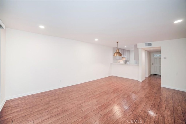 unfurnished living room with baseboards, recessed lighting, visible vents, and light wood-type flooring