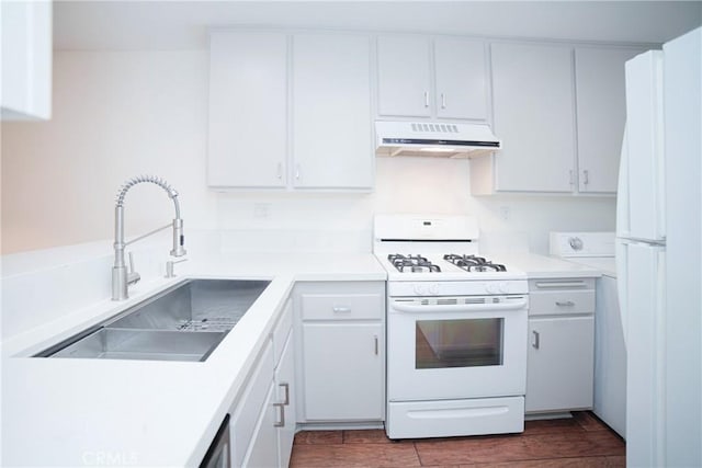 kitchen featuring under cabinet range hood, a sink, white appliances, white cabinets, and light countertops