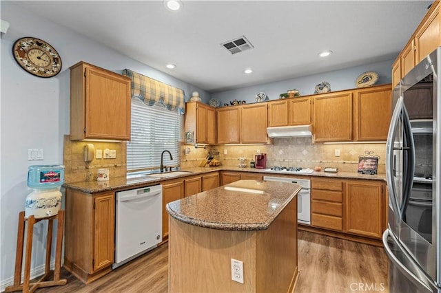 27950 Periwinkle Ln, Valencia, CA 91354 - kitchen featuring white appliances, wood finished floors, a kitchen island, light stone counters, and recessed lighting