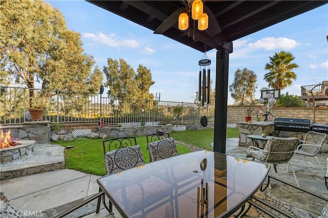 27950 Periwinkle Ln, Valencia, CA 91354 - fenced backyard with an outdoor fire pit, a patio, outdoor dining area, and grilling area