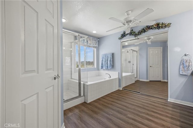27950 Periwinkle Ln, Valencia, CA 91354 - full bath with ceiling fan, a stall shower, a garden tub, wood finished floors, and recessed lighting