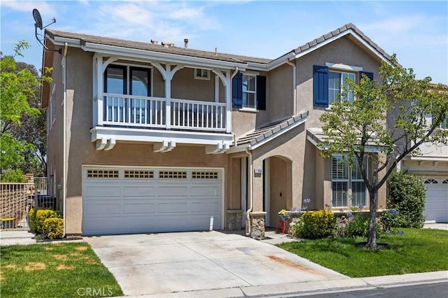 27950 Periwinkle Ln, Valencia, CA 91354 - view of front of house featuring a balcony, an attached garage, stucco siding, and driveway