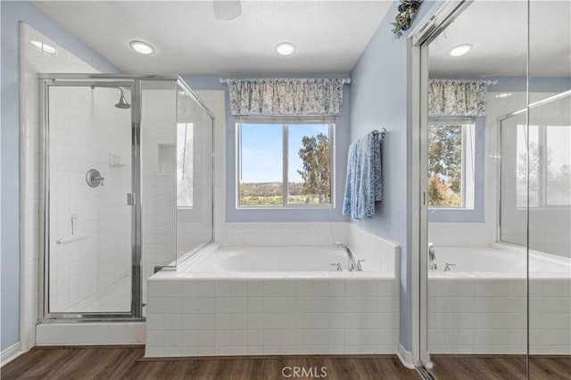 27950 Periwinkle Ln, Valencia, CA 91354 - bathroom with healthy amount of natural light, a stall shower, a bath, and wood finished floors