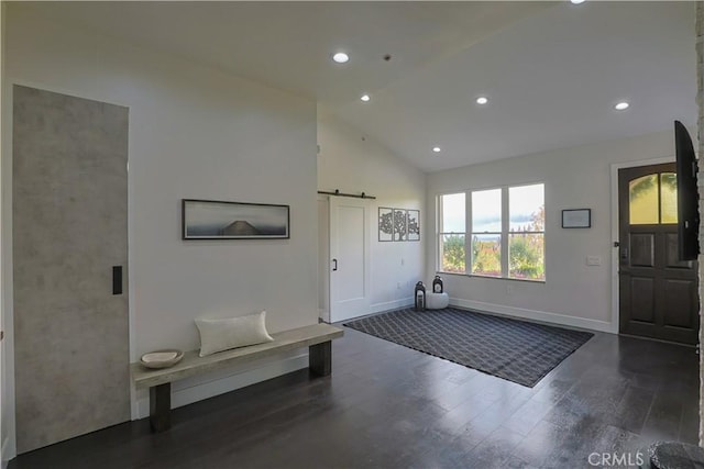 entryway with baseboards, dark wood finished floors, a barn door, recessed lighting, and high vaulted ceiling