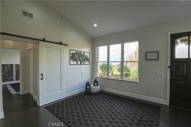 entrance foyer featuring baseboards, visible vents, lofted ceiling, recessed lighting, and a barn door