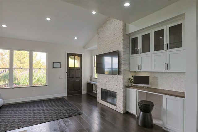 interior space featuring recessed lighting, baseboards, dark wood-style flooring, and vaulted ceiling