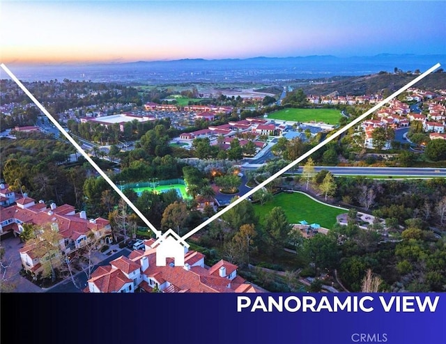 aerial view at dusk featuring a mountain view