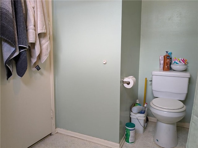 bathroom featuring tile patterned floors, toilet, and baseboards