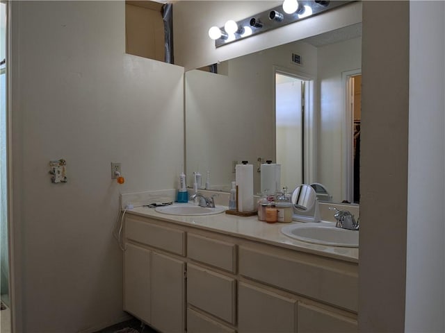 full bathroom with a sink, visible vents, and double vanity