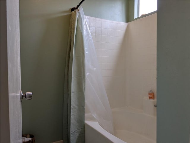 bathroom featuring shower / tub combo with curtain