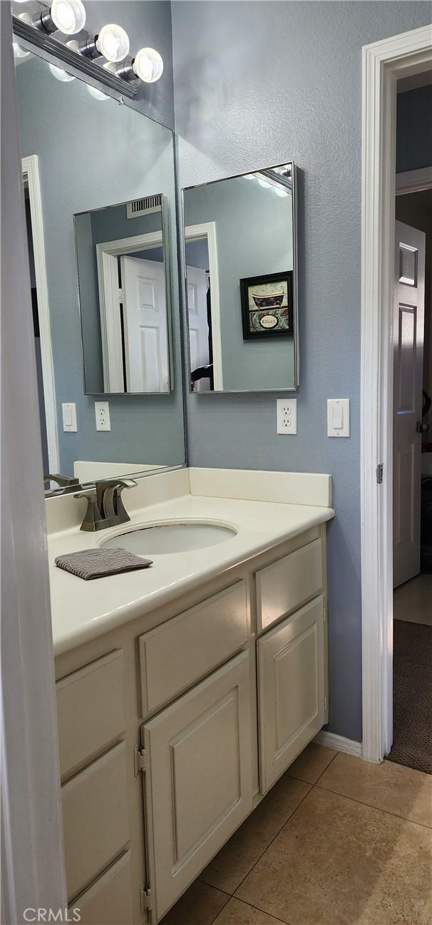 bathroom with tile patterned floors and vanity