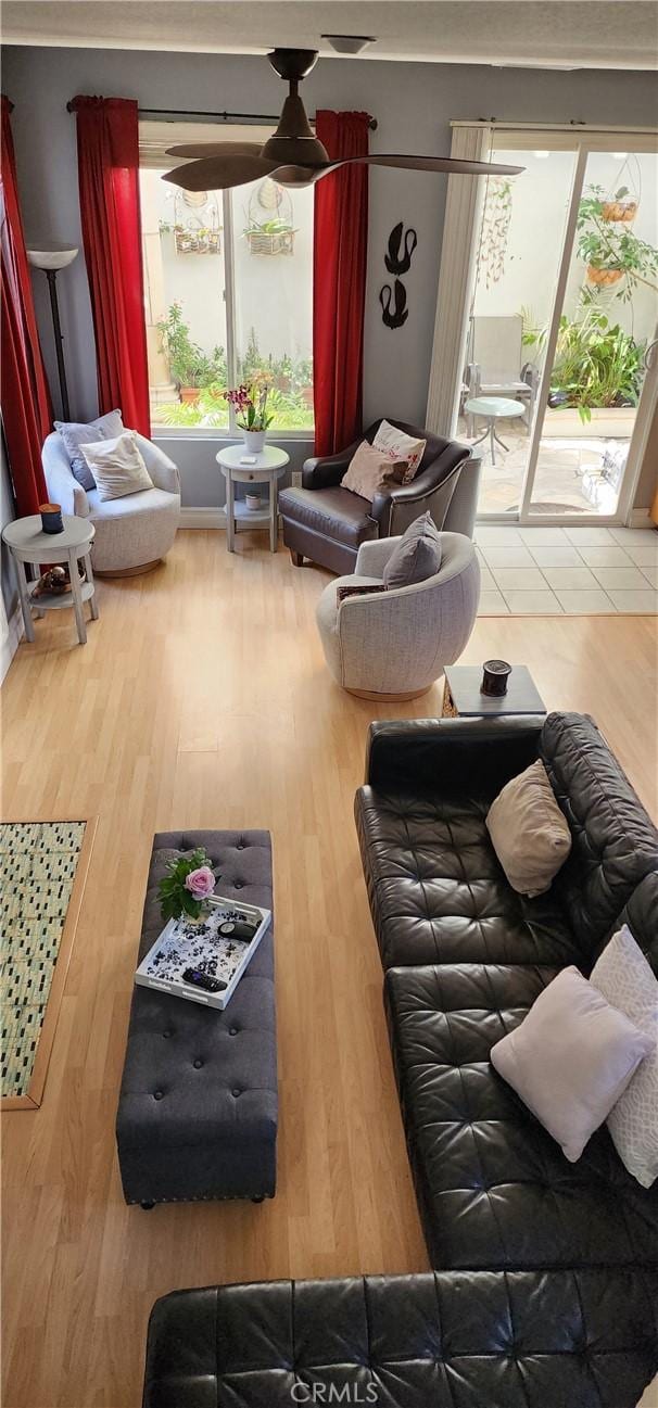 living area featuring wood finished floors and ceiling fan