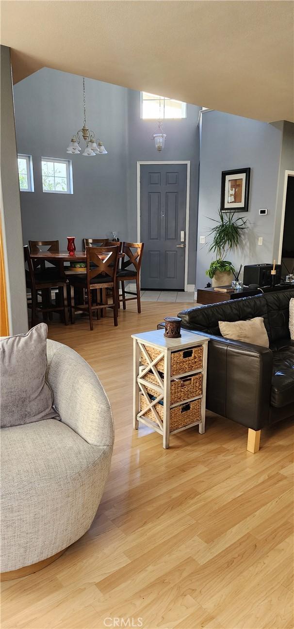 living room featuring a chandelier and light wood finished floors