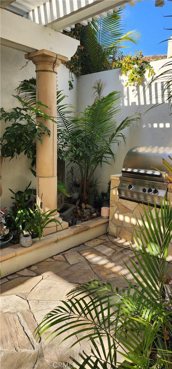 balcony with area for grilling, a pergola, and a patio