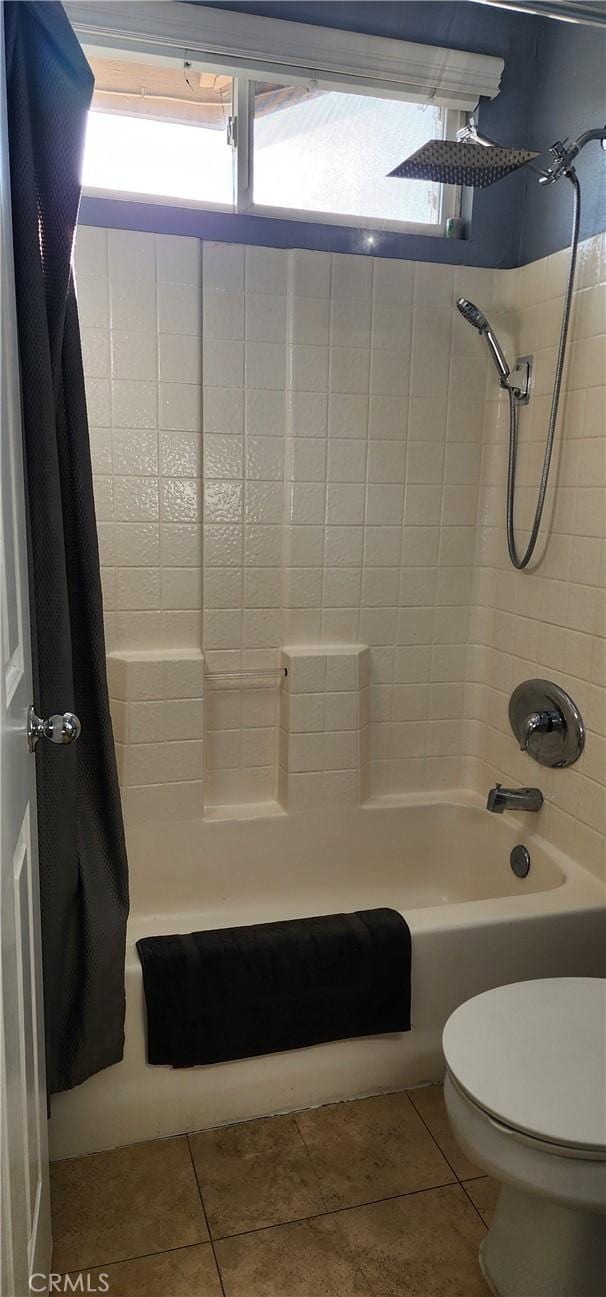 full bathroom with tile patterned floors, toilet, and shower / tub combo with curtain