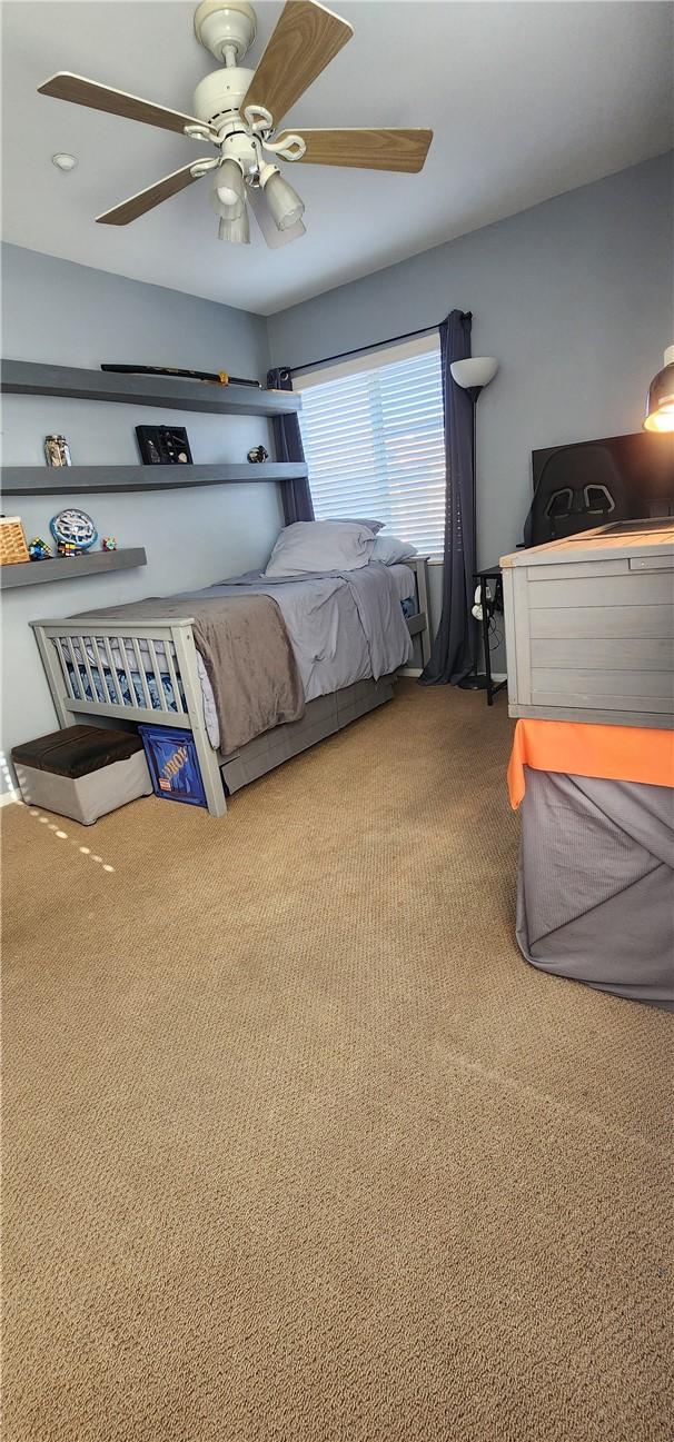 carpeted bedroom featuring a ceiling fan