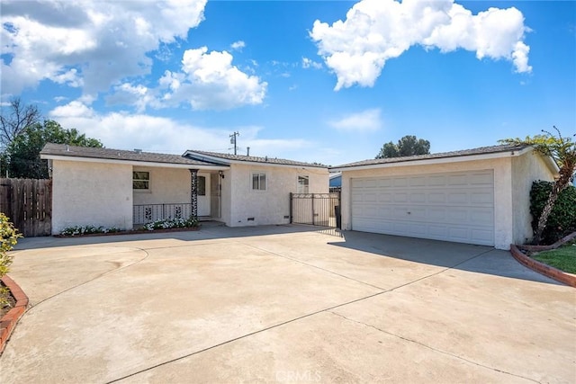 ranch-style house with an outbuilding, stucco siding, a garage, and fence