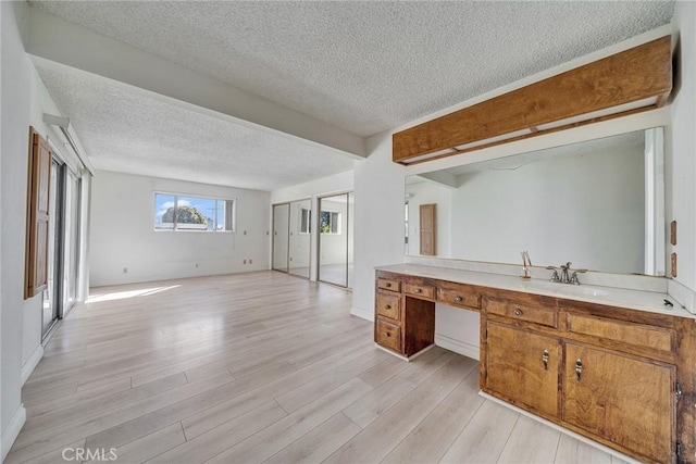 bathroom featuring a textured ceiling, vanity, and wood finished floors