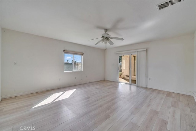 unfurnished room featuring visible vents, baseboards, light wood-type flooring, and a ceiling fan