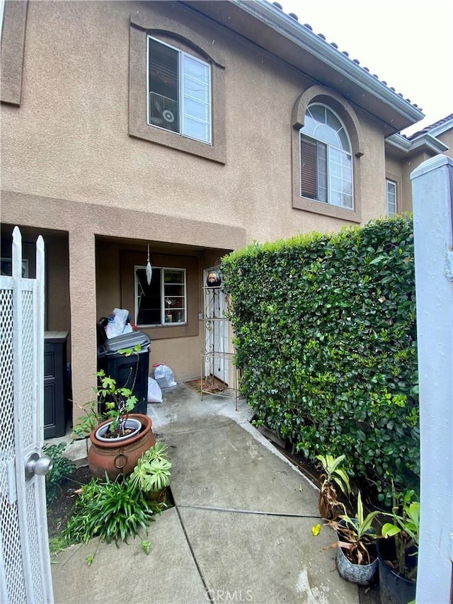 property entrance with stucco siding