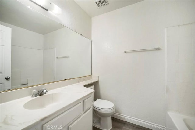 full bath featuring visible vents, toilet, wood finished floors, baseboards, and vanity