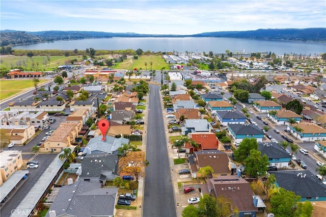 drone / aerial view featuring a residential view and a water view