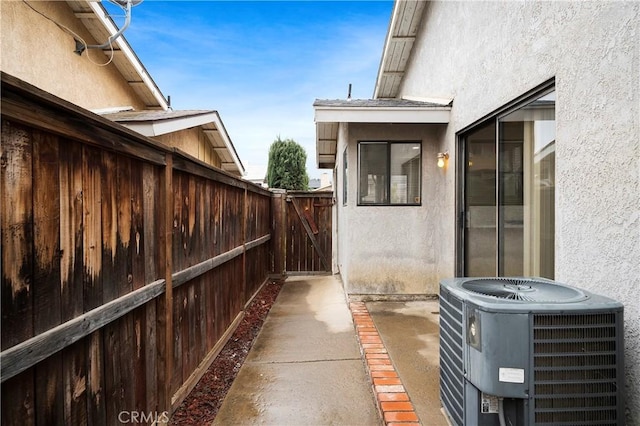 view of patio / terrace featuring fence and central AC