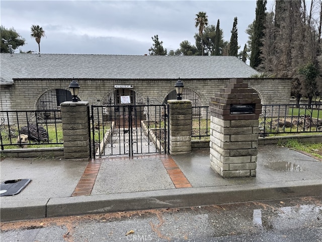 view of gate with fence