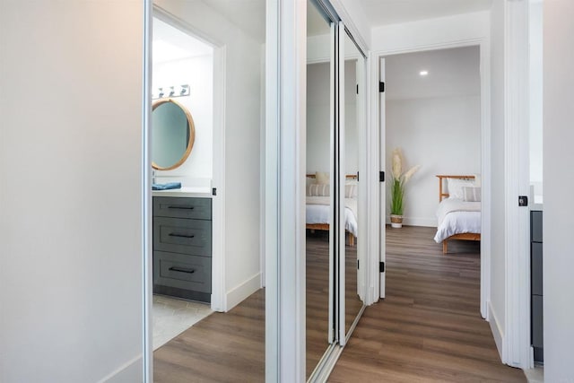 hallway with baseboards and wood finished floors