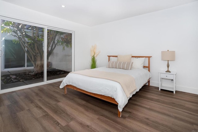 bedroom with recessed lighting, baseboards, wood finished floors, and access to outside