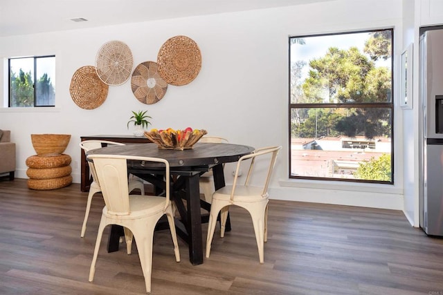 dining area featuring wood finished floors and visible vents