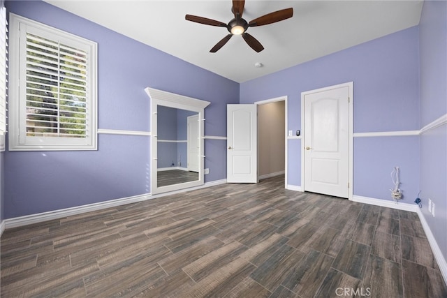 unfurnished bedroom with a ceiling fan, wood finished floors, and baseboards