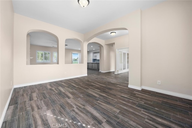 empty room featuring dark wood finished floors and baseboards