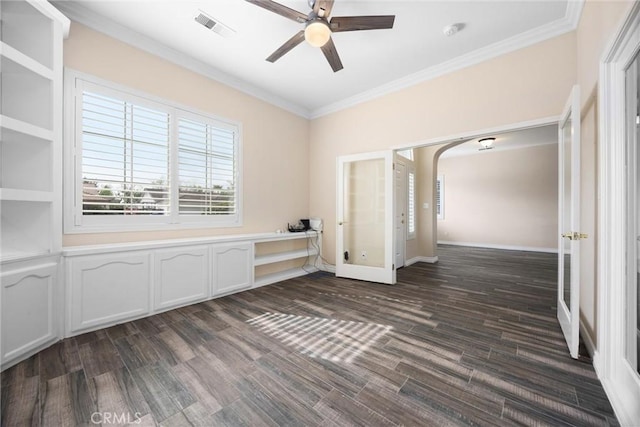 unfurnished room with visible vents, dark wood-type flooring, ceiling fan, ornamental molding, and french doors