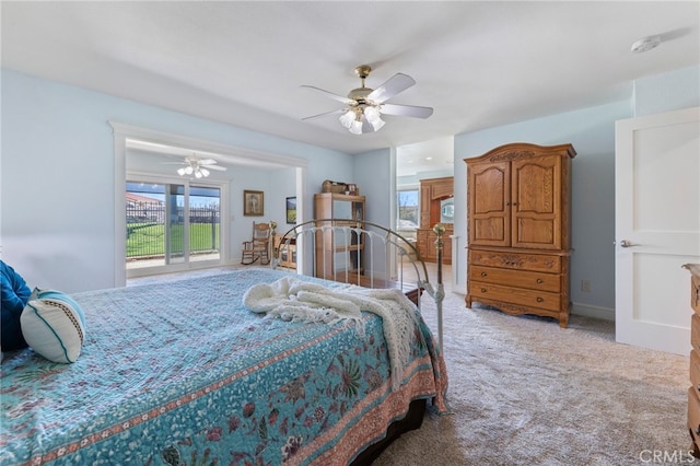 bedroom featuring light colored carpet, baseboards, and ceiling fan