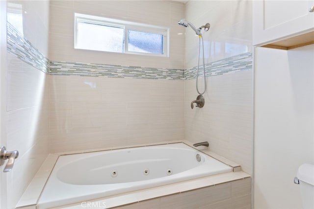 full bathroom featuring toilet and a combined bath / shower with jetted tub