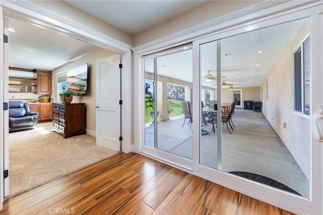 entryway with light wood-style flooring and ceiling fan