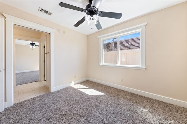 unfurnished bedroom with baseboards, visible vents, carpet floors, and ceiling fan