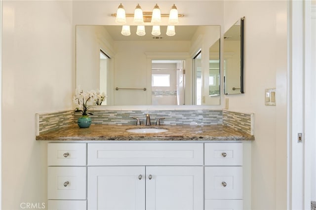 bathroom featuring decorative backsplash and vanity