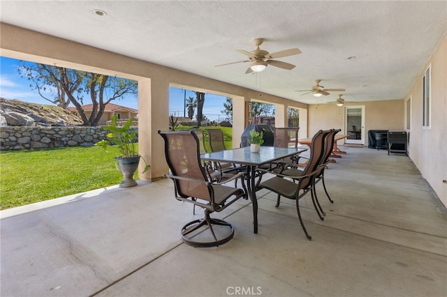 view of patio with outdoor dining space and ceiling fan